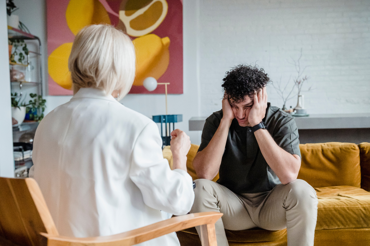 Adult sitting at a desk reflecting on signs of autism in adults and considering an evaluation